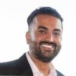 AI professional smiling, wearing a suit, representing innovative recruitment process outsourcing solutions at RPO AI.
